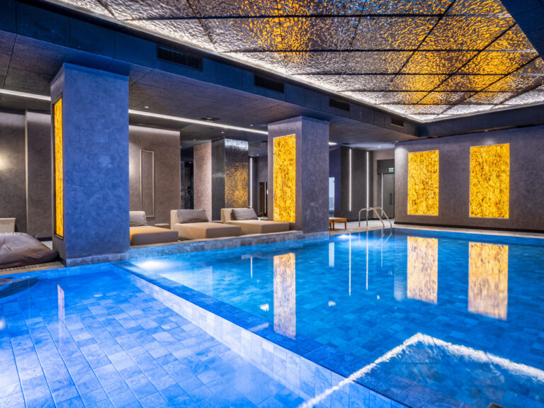Indoor heated pool with blue lighting at Premier Luxury Mountain Resort, Bansko