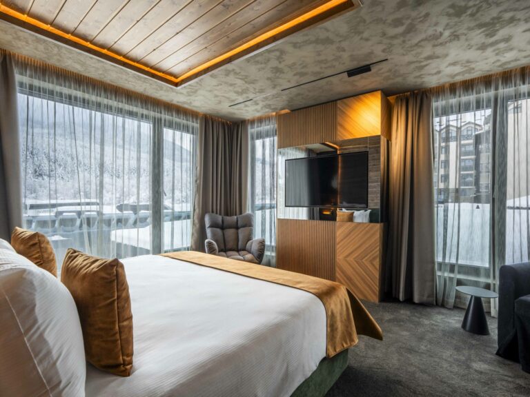 Hotel room with double bed and large windows at Premier Luxury Mountain Resort, Bansko