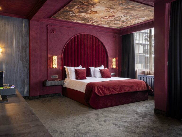 Bedroom with burgundy walls at Premier Luxury Mountain Resort, Bansko