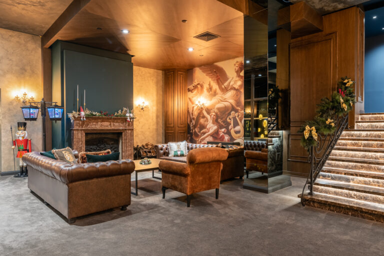 Lobby lounge with fireplace and leather armchairs at Premier Luxury Mountain Resort, Bansko