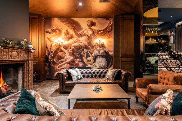 Lobby lounge with fireplace and armchairs at Premier Luxury Mountain Resort, Bansko