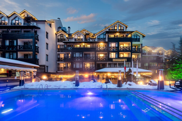 Hotel and outdoor pool at dusk at Premier Luxury Mountain Resort, Bansko