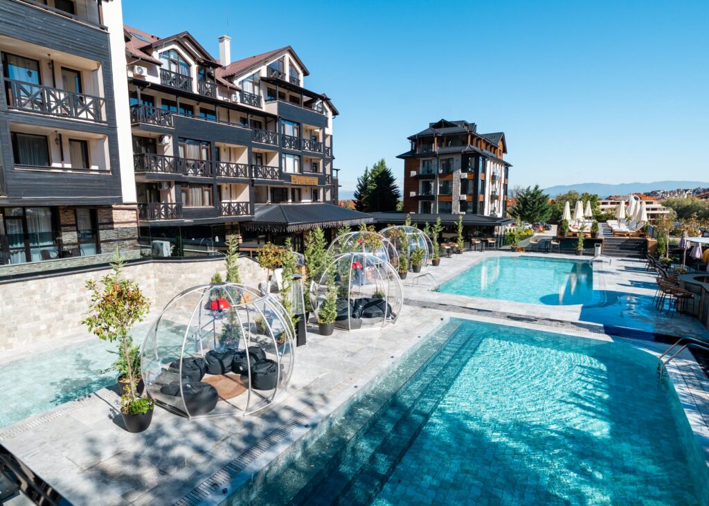 Transparent igloos on the pool terrace beside the outdoor pools at Premier Luxury Mountain Resort, Bansko
