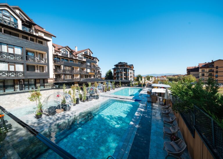 Outdoor pool and terrace with transparent igloos at Premier Luxury Mountain Resort, Bansko