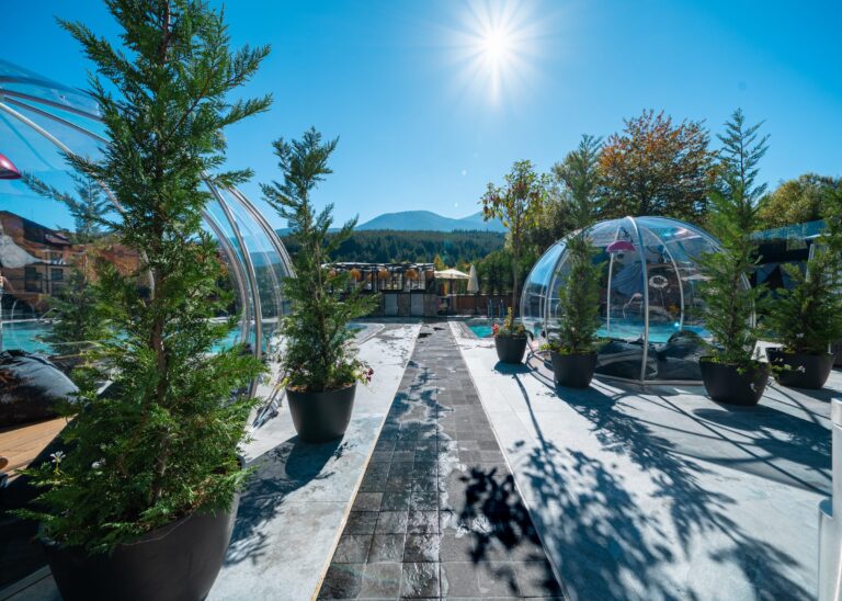Igloos and potted conifers on the sunny pool terrace at Premier Luxury Mountain Resort, Bansko