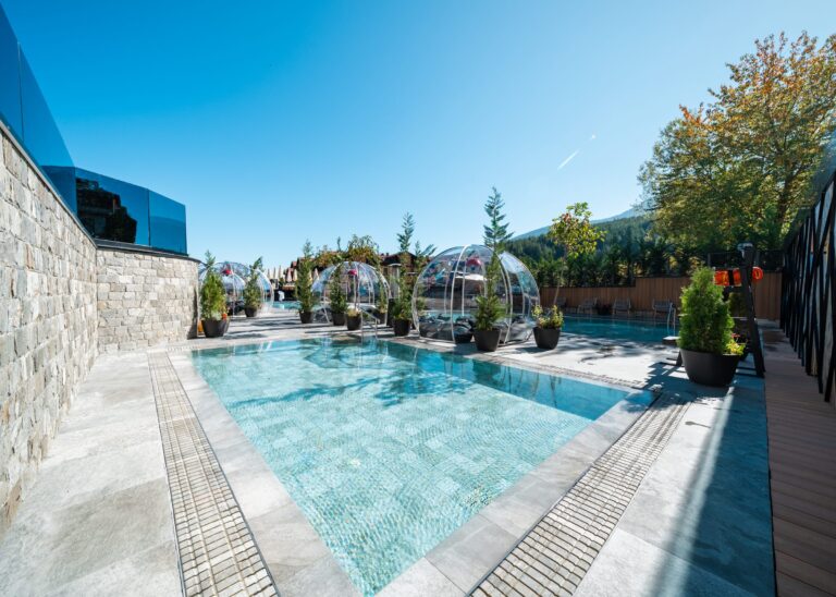 Pool terrace with igloos beside the stone wall at Premier Luxury Mountain Resort, Bansko