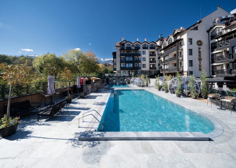 Outdoor pool and terrace with igloos in front of the hotel at Premier Luxury Mountain Resort, Bansko