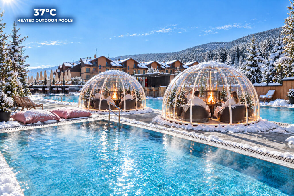 Heated outdoor pool with glass igloos in winter at Premier Luxury Mountain Resort, Bansko