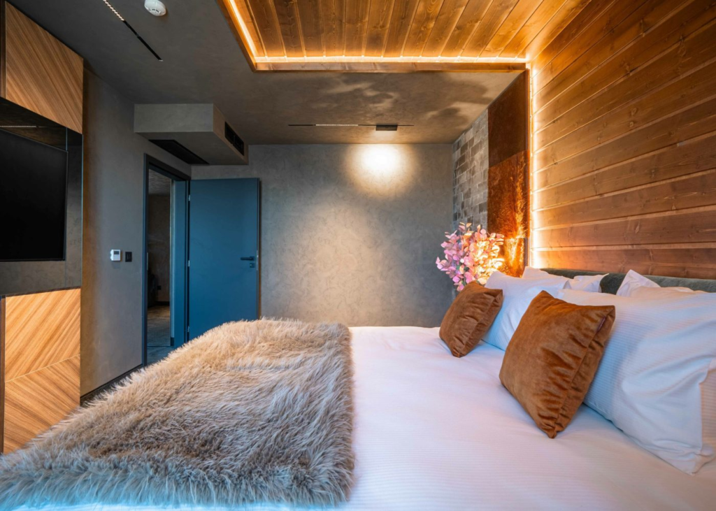 Deluxe room with wooden accent wall at Premier Luxury Mountain Resort