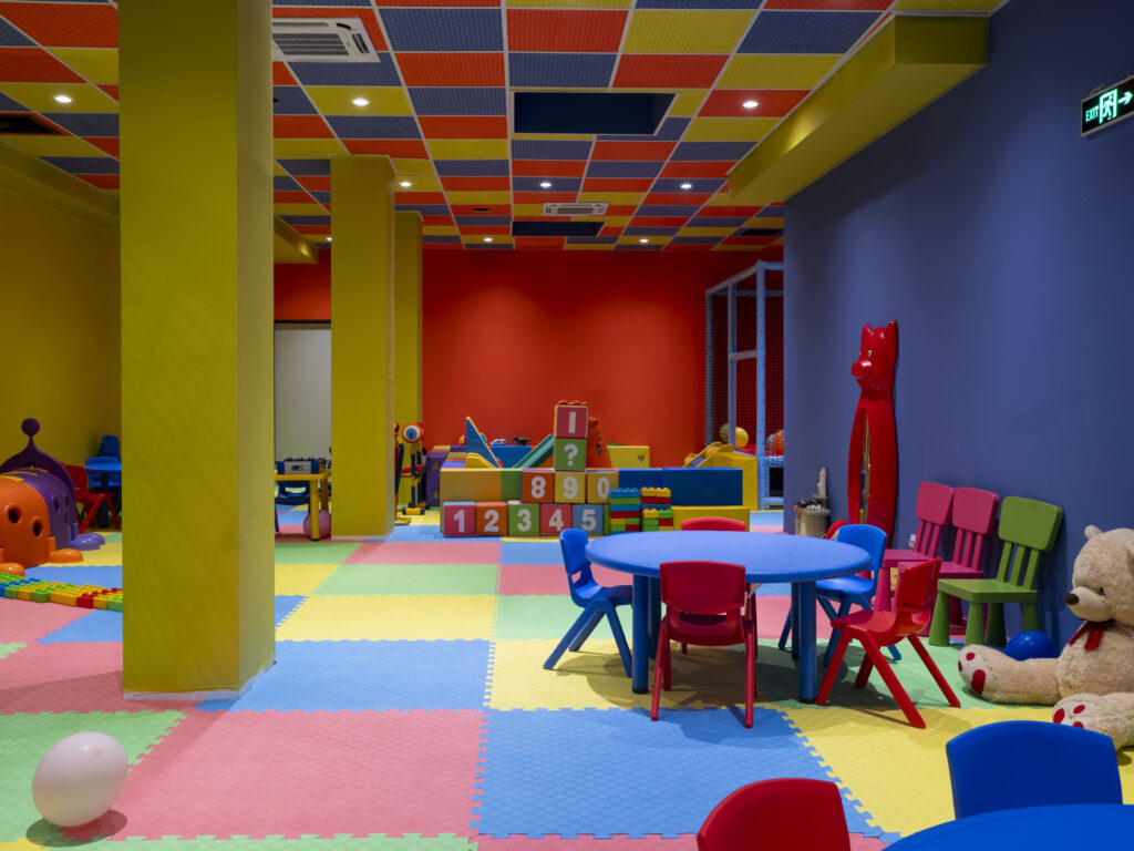 Kids' club with tables, toys and play equipment at Premier Luxury Mountain Resort, Bansko