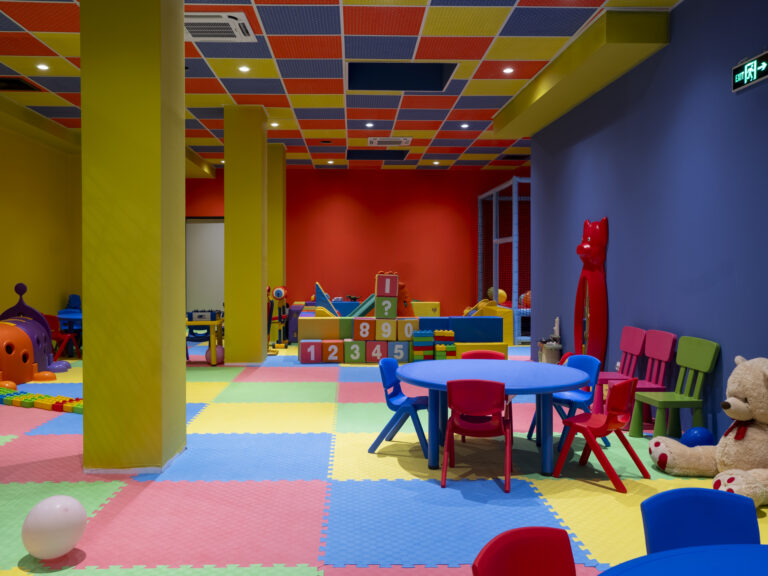 Kids' club with tables, toys and play equipment at Premier Luxury Mountain Resort, Bansko