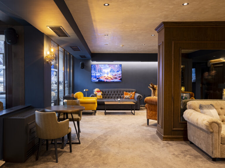 Lounge with sofas and a large TV at Premier Luxury Mountain Resort, Bansko