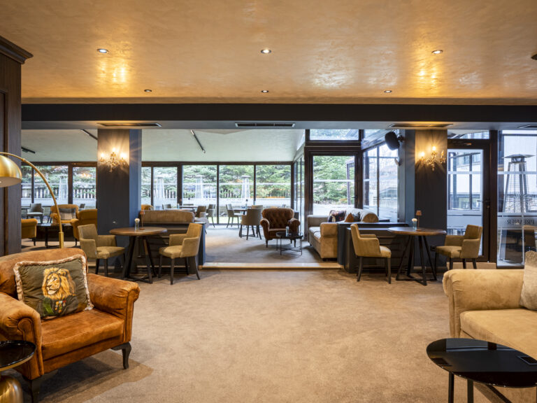 Lounge with armchairs and garden-view windows at Premier Luxury Mountain Resort, Bansko