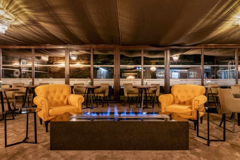 Lounge seating around a fire table at Premier Luxury Mountain Resort, Bansko