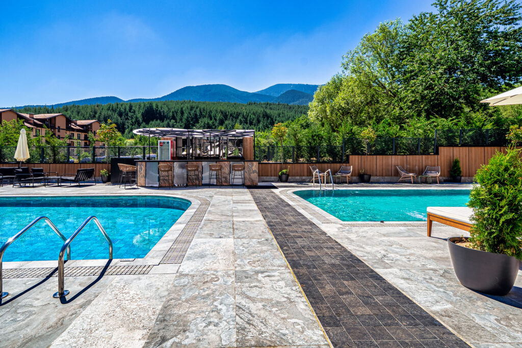 Heated outdoor pool with Pirin mountain views at Premier Luxury Mountain Resort, Bansko