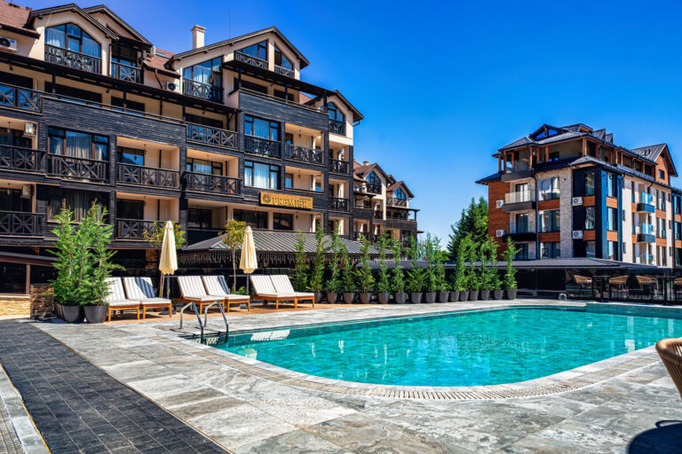 Large heated outdoor pool with Pirin mountain views at Premier Luxury Mountain Resort, Bansko