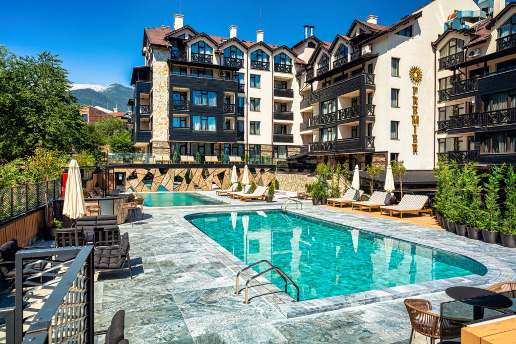 Large heated outdoor pool with Pirin mountain views at Premier Luxury Mountain Resort, Bansko