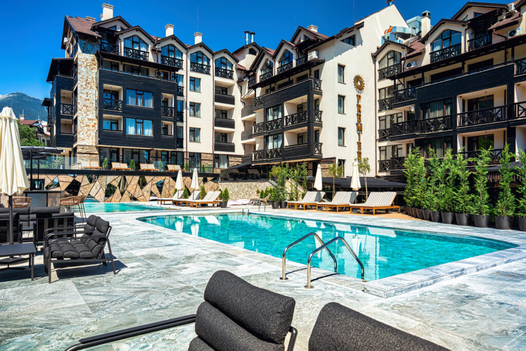 Large heated outdoor pool with Pirin mountain views at Premier Luxury Mountain Resort, Bansko