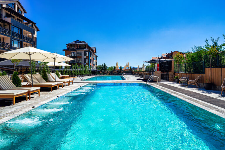 Heated outdoor pool with hydromassage jets at Premier Luxury Mountain Resort, Bansko