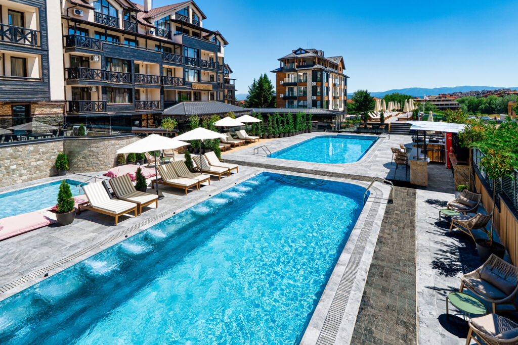 Heated outdoor pool with hydromassage jets at Premier Luxury Mountain Resort, Bansko