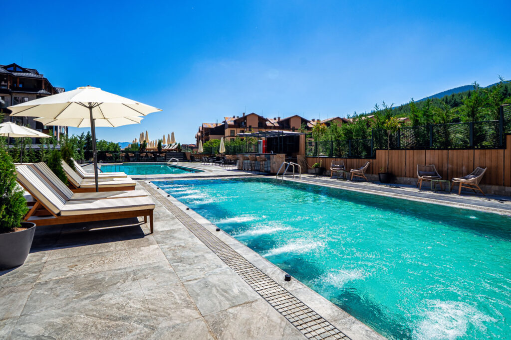 Heated outdoor pool with hydromassage jets at Premier Luxury Mountain Resort, Bansko