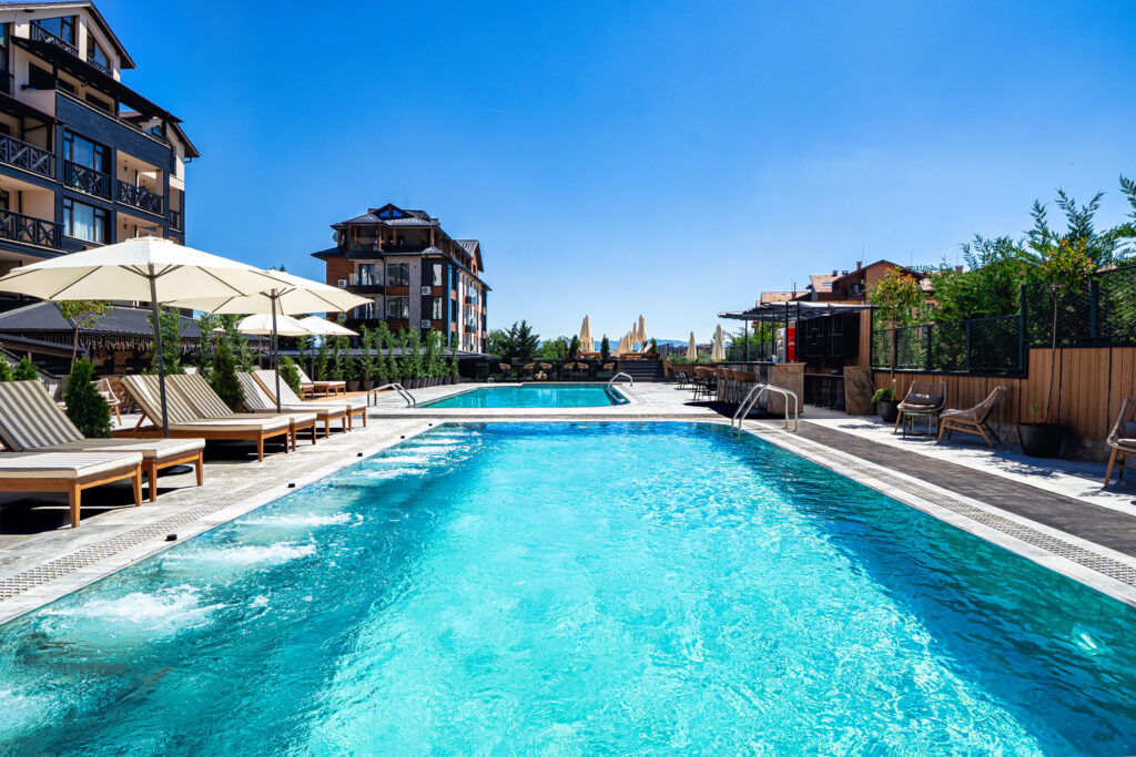 Heated outdoor pool with hydromassage jets at Premier Luxury Mountain Resort, Bansko