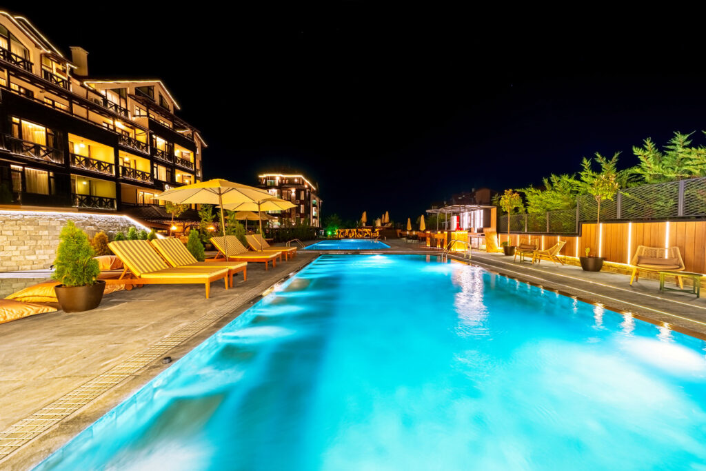 Illuminated outdoor pool at night at Premier Luxury Mountain Resort, Bansko